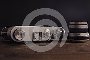 old vintage soviet camera with lens on wooden background