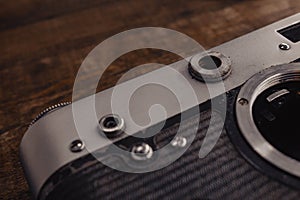 old vintage soviet camera with lens on wooden background