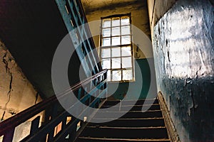 Old vintage staircase interior in dark dirty abandoned building