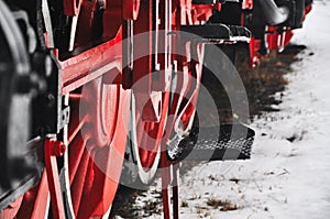 Old vintage steam train, locomotive, train with red wheels, old carriages, close-up to the wheels