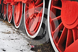 Old vintage steam train, locomotive, train with red wheels, old carriages, close-up to the wheels