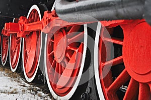 Old vintage steam train, locomotive, train with red wheels, old carriages, close-up to the wheels