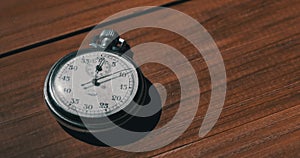Old Vintage Stopwatch Lies on Wooden Table and Counts the Seconds