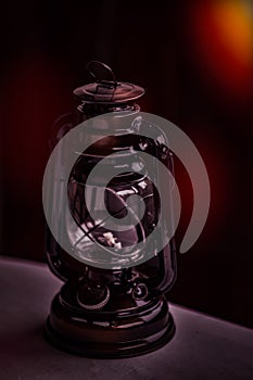 Old vintage style retro kerosene lamp or nostalgic paraffin lamp on the table - decorative antique rustic lamp, aged metal lantern photo