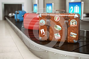 Old vintage suitcase on a airport luggage conveyor belt. Baggage claim. Travel and tourism concept background