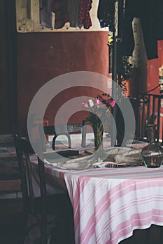 Old vintage table and traditional chairs and water pot and flowers