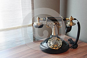 Old vintage telephone on a desk