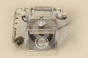 Old vintage telephone with handset on cradle