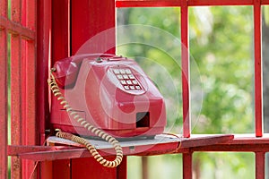 Old vintage telephone or phone in red box.