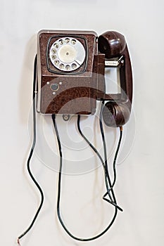 Old vintage telephone on white wall