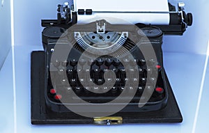 Old vintage typewriter with a blank sheet of paper inserted