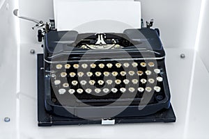 Old vintage typewriter with a blank sheet of paper inserted