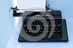 Old vintage typewriter with a blank sheet of paper inserted