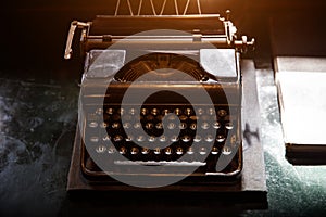 Old vintage typewriter on the desktop.