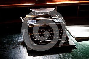 Old vintage typewriter on the desktop.