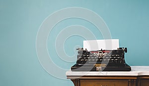 Old vintage typewriter on a table over an isolated background.