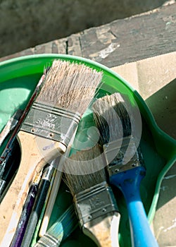 Old, vintage, used paint brushes in vary sizes in green plastic