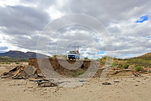 Old vintage van on damaged and washed out road in Baja California, Mexico