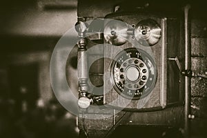 Old vintage wall mount telephone with brass bells in monochrome - retro photography