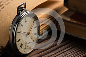 Old vintage watch on books background close up