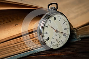 Old vintage watch on books background close up