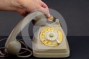 old vintage wheel phone and hand with telephone token.