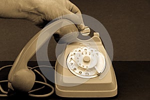 old vintage wheel phone and hand with telephone token.