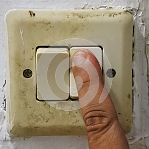 An old vintage white light switch on off