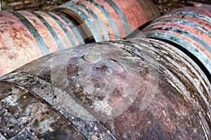 Old vintage wine barrels in wine cellar in Tuscany.