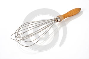 Old vintage wire whisk isolated over white