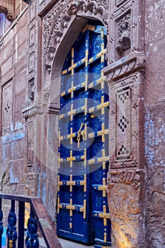 Old vintage wood carved door in blue city of Jodhpur, India