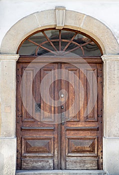 Old vintage wooden brown door close-up with insertions and patterns on glasspatterns on glass