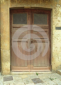 Old vintage wooden rustic door on rural home wall