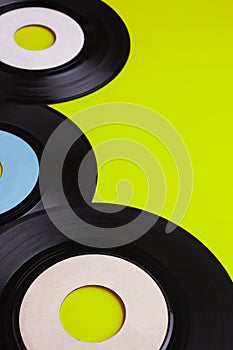 Old Vinyl 45 rpm Records on green background