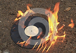 The old vinyl black plate burns on a stone surface