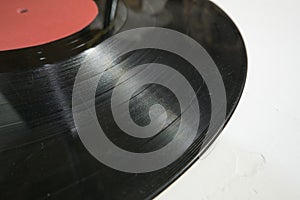 Old vinyl record in paper case on white marble background