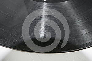 Old vinyl record in paper case on white marble background