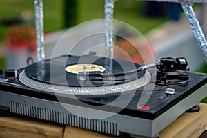 Old vinyl record player at the garden party - image