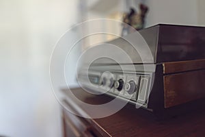 An old vinyl record player with wooden cases