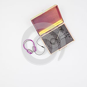 Old vinyl turntable player with headphones with record isolated on a white background