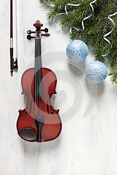 Old violin and fir-tree branches with Christmas decor and white poinsettia. Christmas, New Year\'s concept.