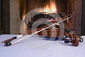 Old violin by the fireplace