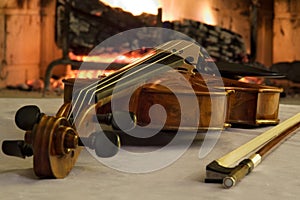 Old violin by the fireplace