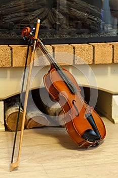 Old violin by the fireplace