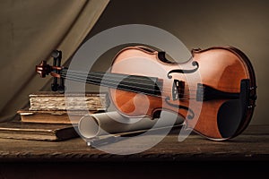 Old violin still life with books photo