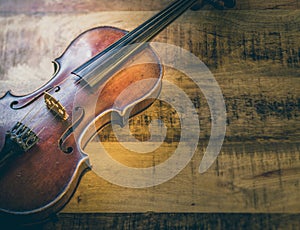 Old violin on a wooden background