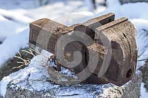 Old vise to clamp the tool in the cold under the snow