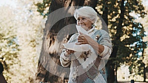 Old vulnerable homeless woman getting free charity meal