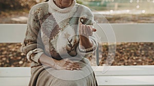 Old vulnerable lost or homeless woman getting coins. Dementia and mental issues concept