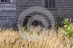 Old wagon wheel against the barn